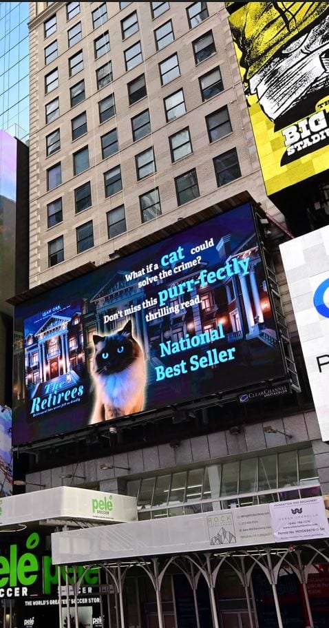 The Retirees billboard in Times Square featuring a cat and National Best Seller banner